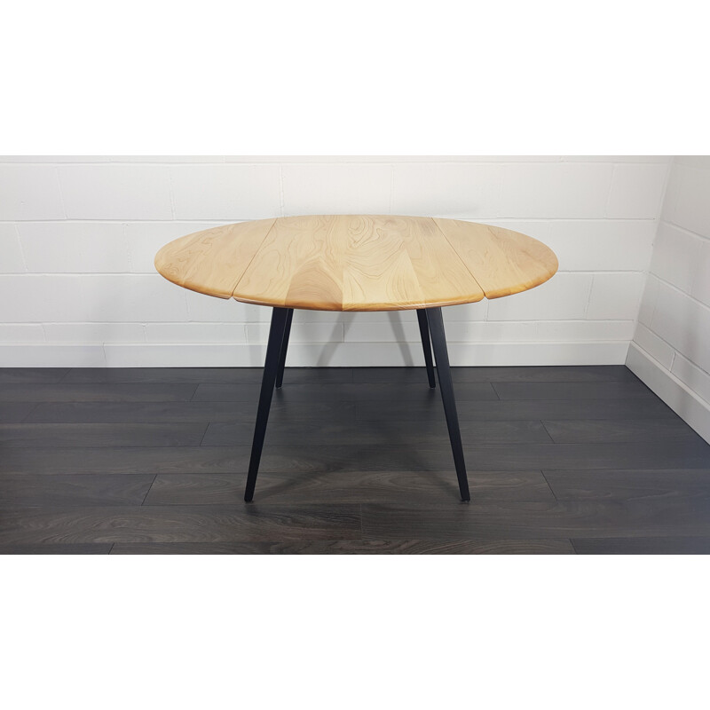 Vintage Ercol black leg round drop leaf dining table, 1960s