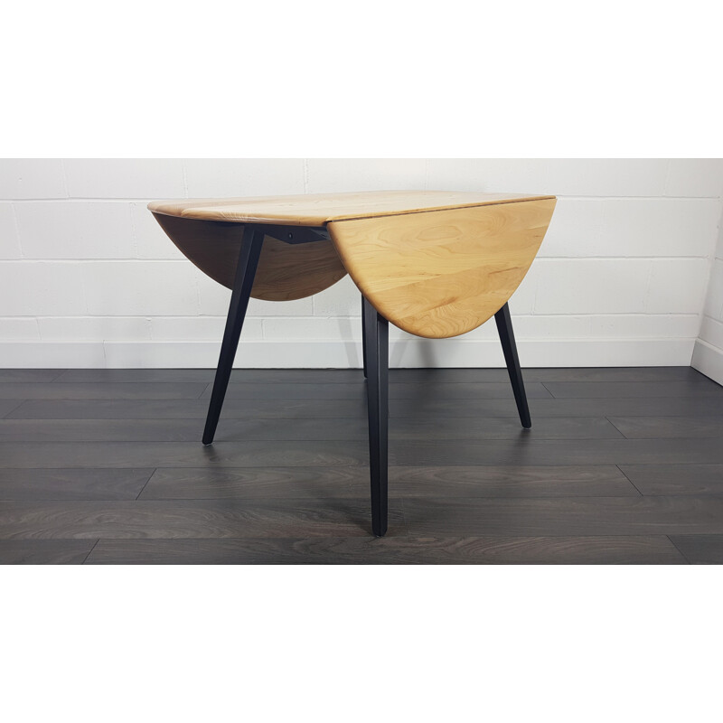 Vintage Ercol black leg round drop leaf dining table, 1960s