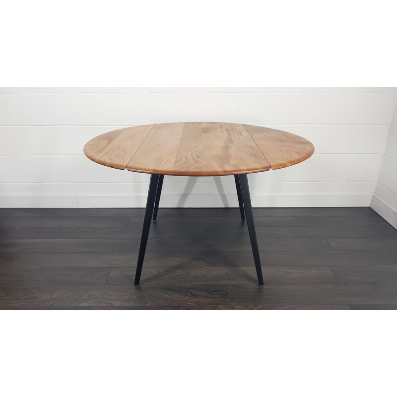 Vintage Ercol black leg round drop leaf dining table, 1960s