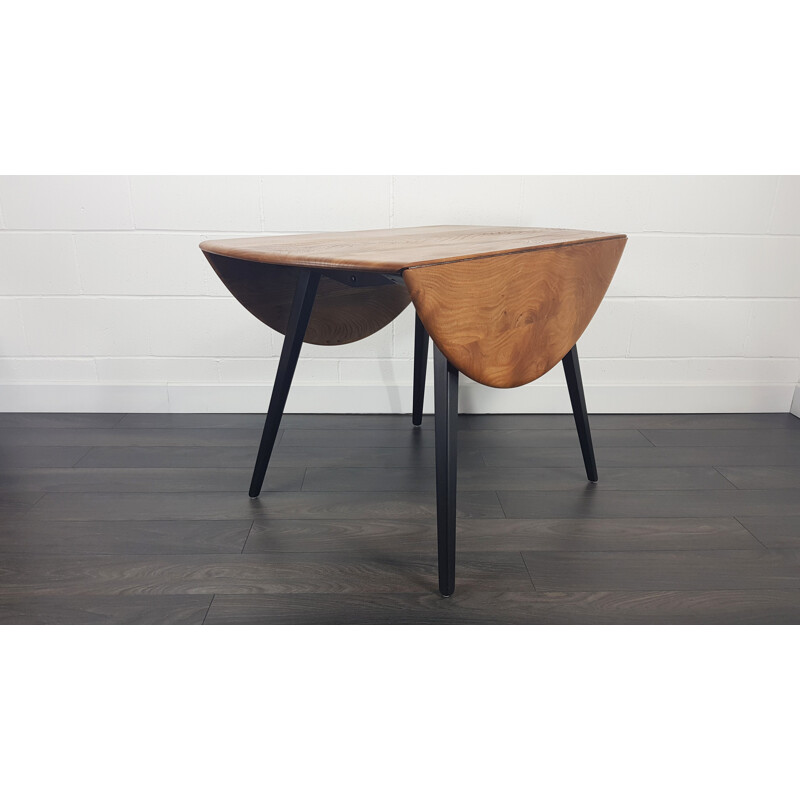 Vintage Ercol black leg round drop leaf dining table, 1960s