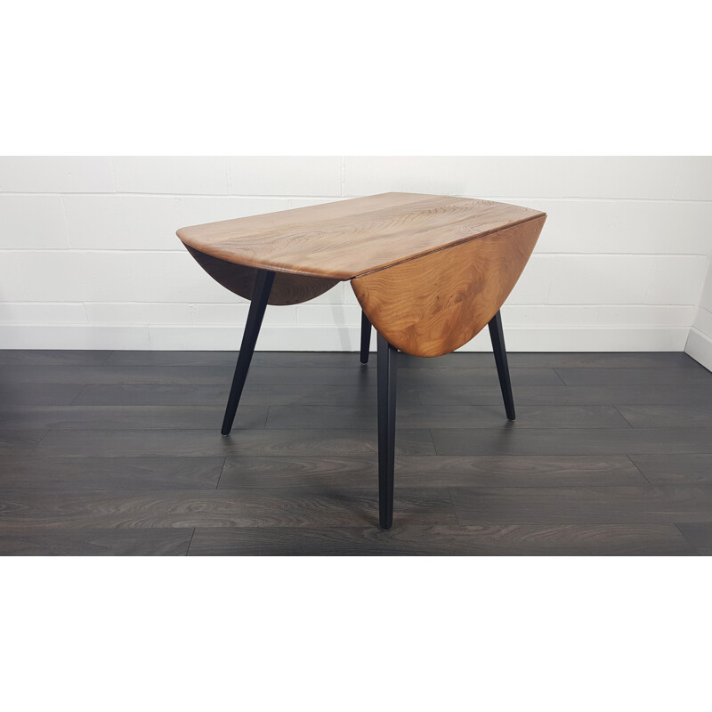 Vintage Ercol black leg round drop leaf dining table, 1960s