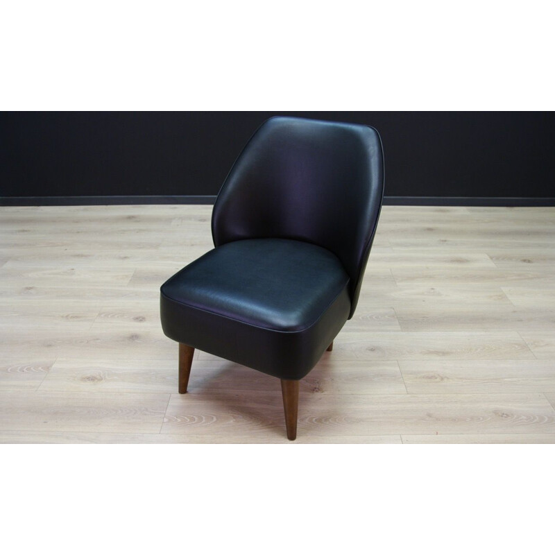 Vintage wooden armchair in black leather