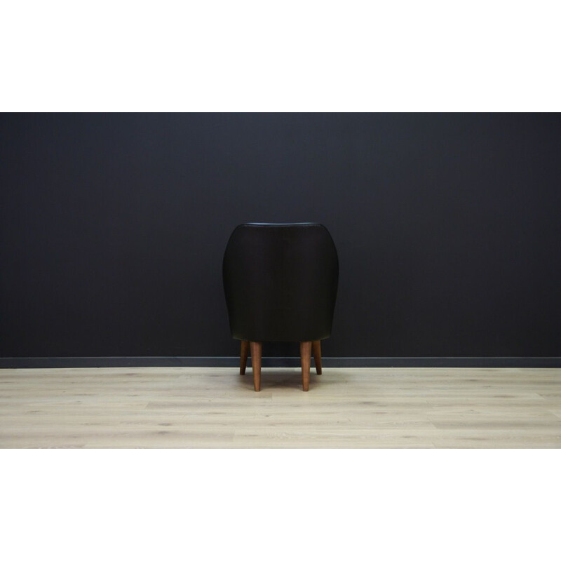 Vintage wooden armchair in black leather