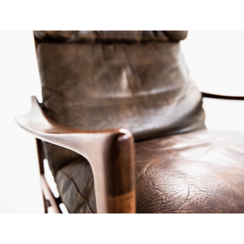 Vintage  easy chair and ottoman in teak and leather by Ib Kofod Larsen