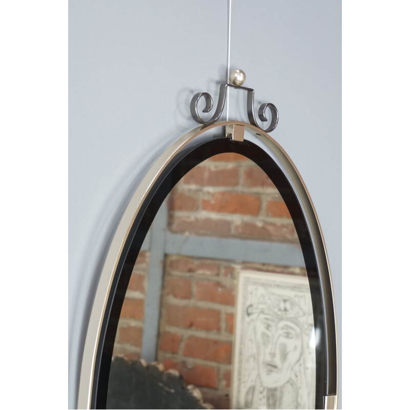 Vintage oval mirror suspended in chrome