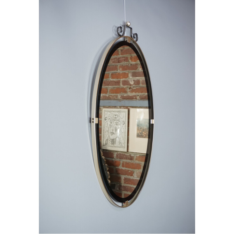 Vintage oval mirror suspended in chrome