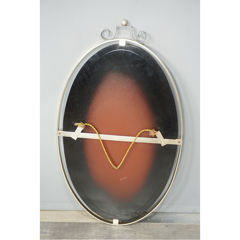 Vintage oval mirror suspended in chrome