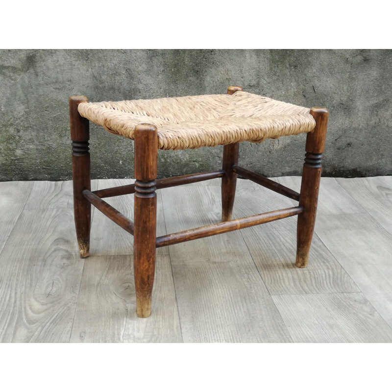 Vintage stool made of wood and woven straw