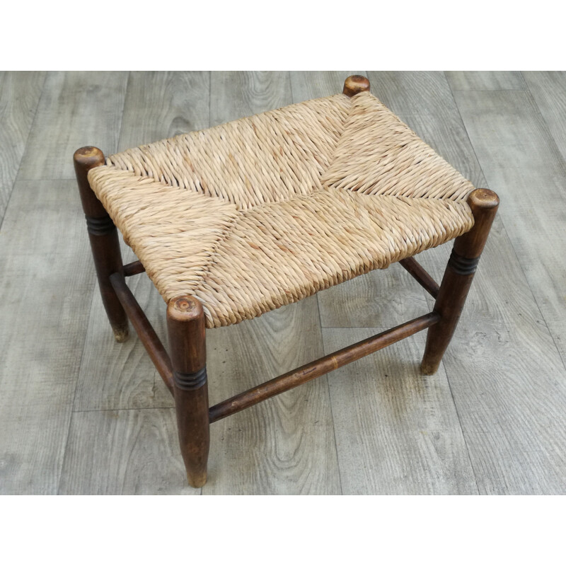 Vintage stool made of wood and woven straw