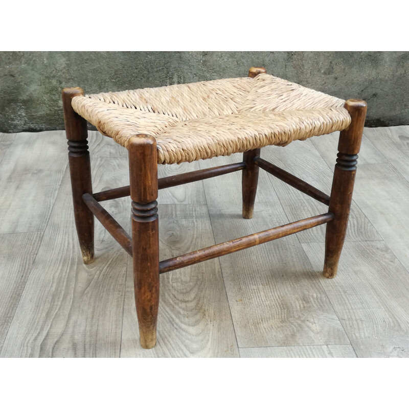 Vintage stool made of wood and woven straw