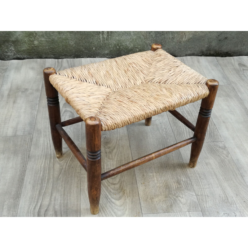 Vintage stool made of wood and woven straw