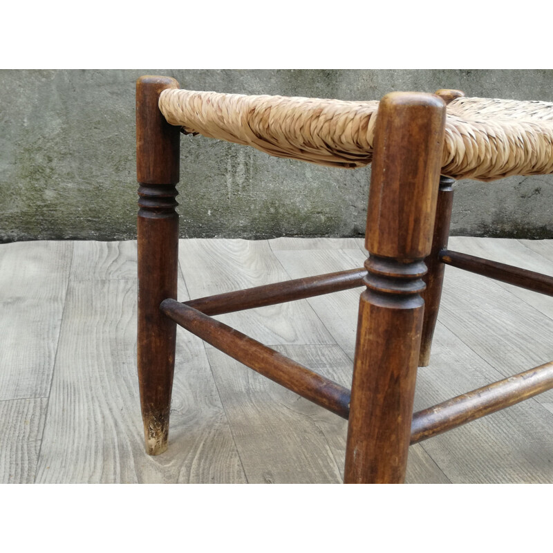 Vintage stool made of wood and woven straw