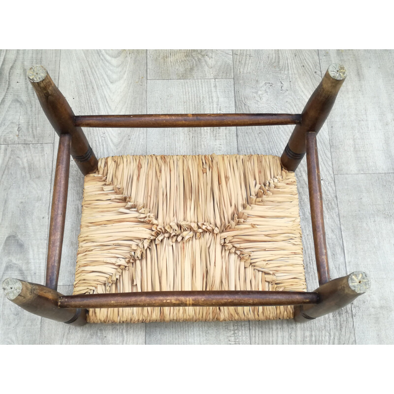 Vintage stool made of wood and woven straw
