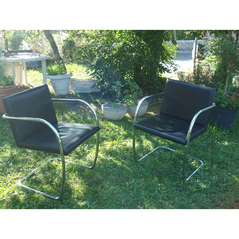 Suite of 8 black leather and chrome armchairs