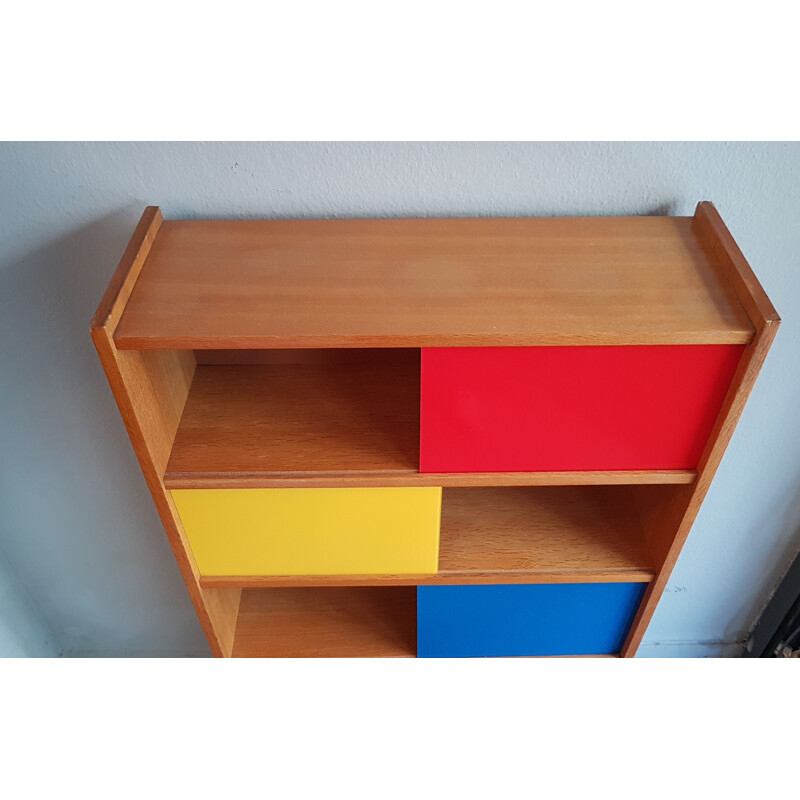 Bookcase with colored sliding windows from the 60's