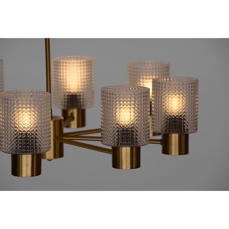 Brass eight arm chandelier with glass shades by HJA. Sweden 1960s