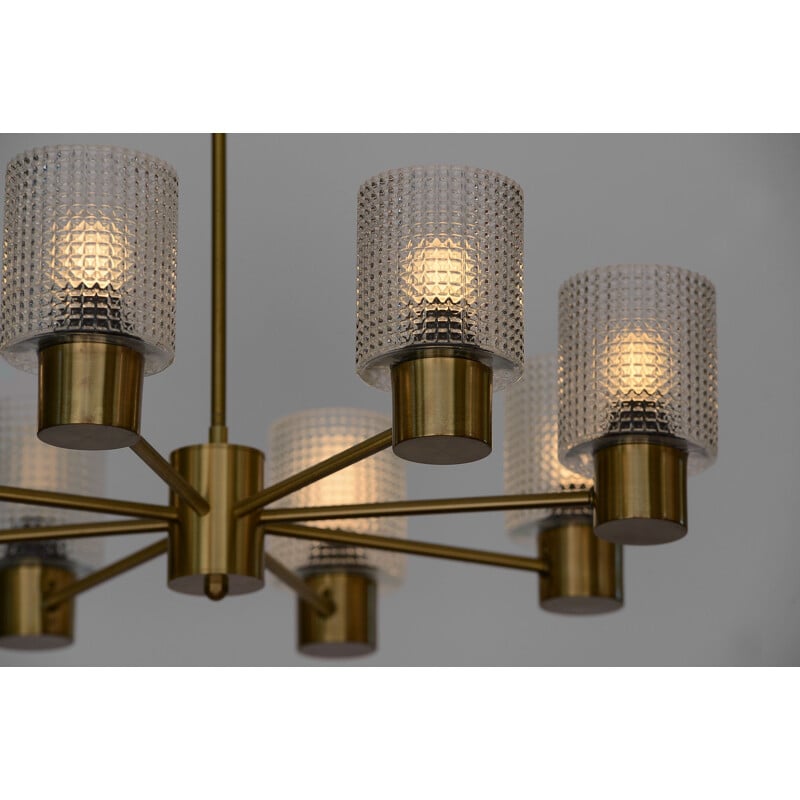 Brass eight arm chandelier with glass shades by HJA. Sweden 1960s