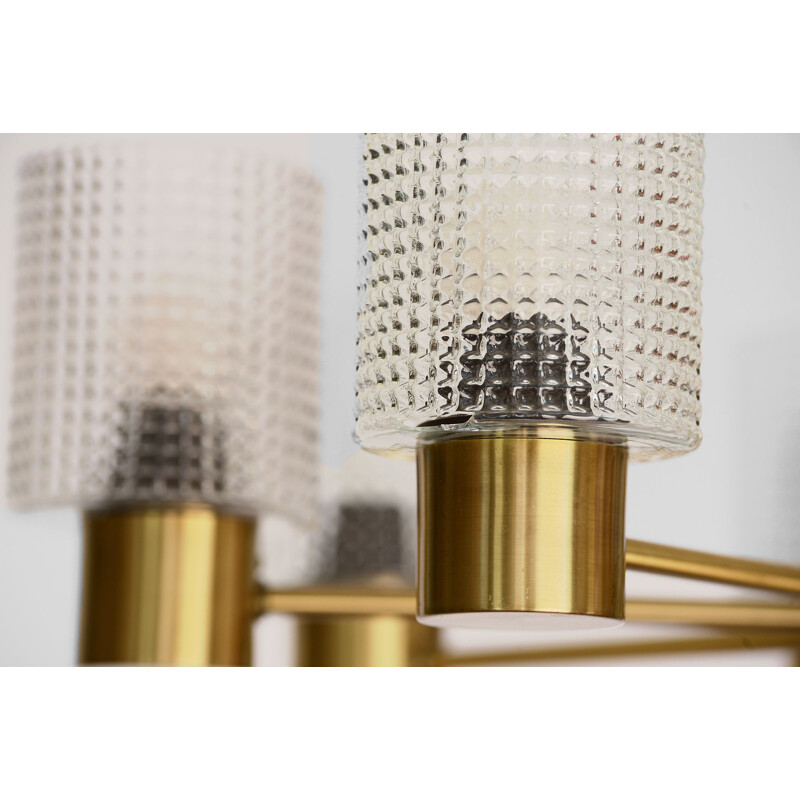 Brass eight arm chandelier with glass shades by HJA. Sweden 1960s