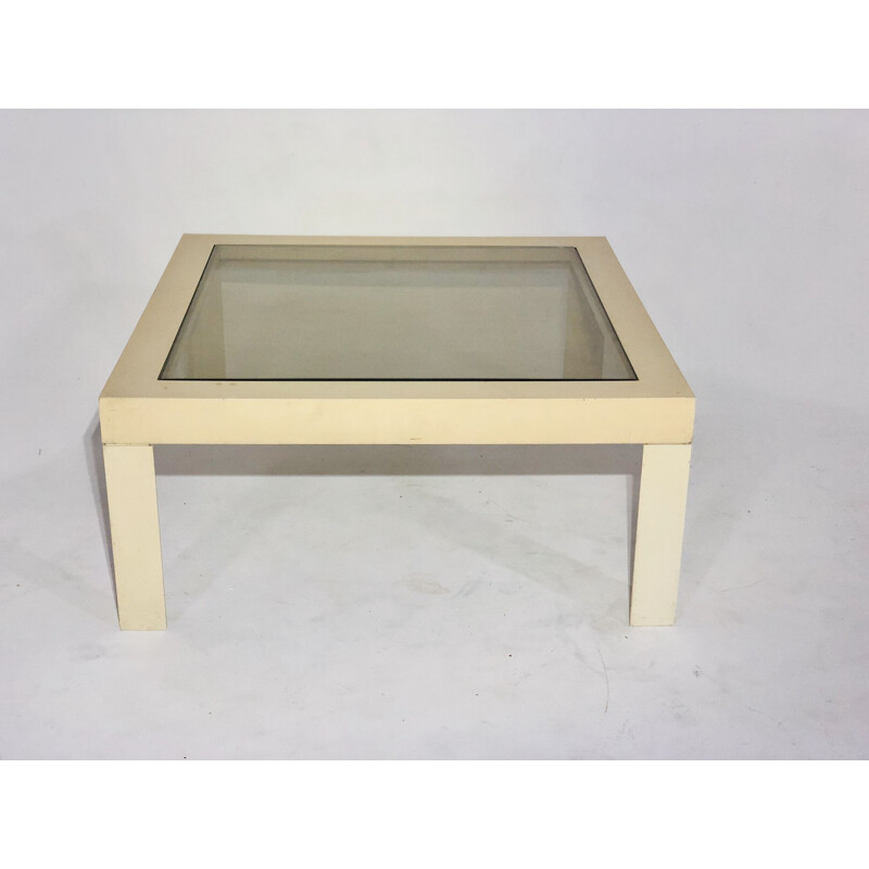 White plastic coffee table with glass top