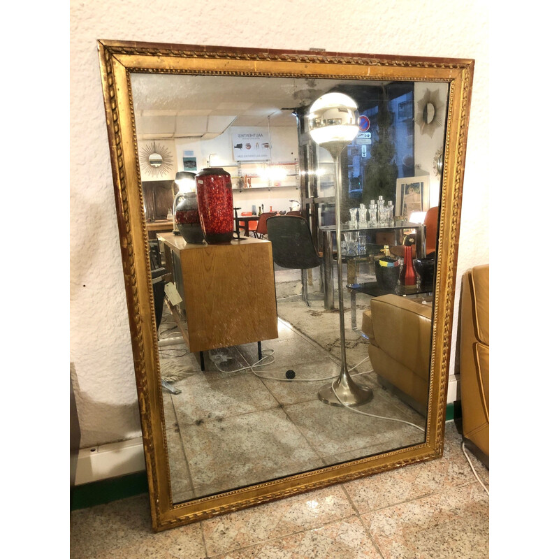 Large vintage mirror in gold plated wood, stained with mercury.