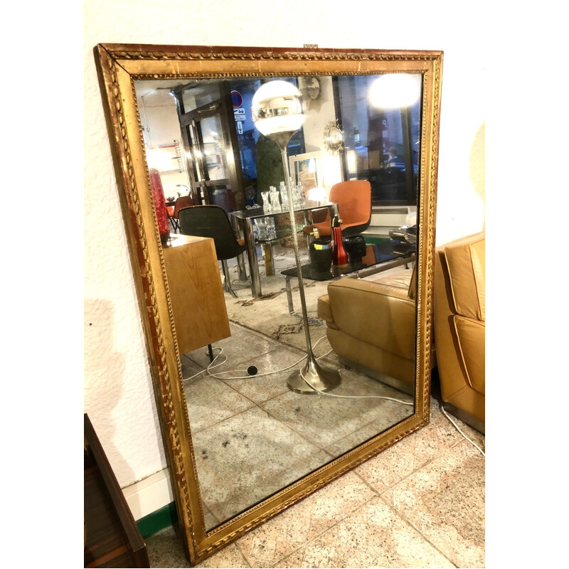 Large vintage mirror in gold plated wood, stained with mercury.