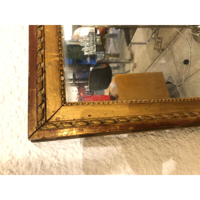 Large vintage mirror in gold plated wood, stained with mercury.