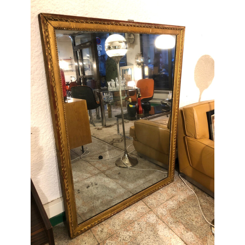 Large vintage mirror in gold plated wood, stained with mercury.