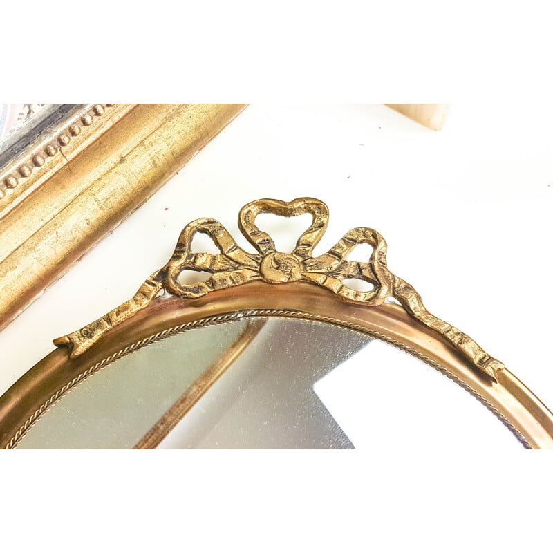 Vintage round brass mirror with 1950's golden bow