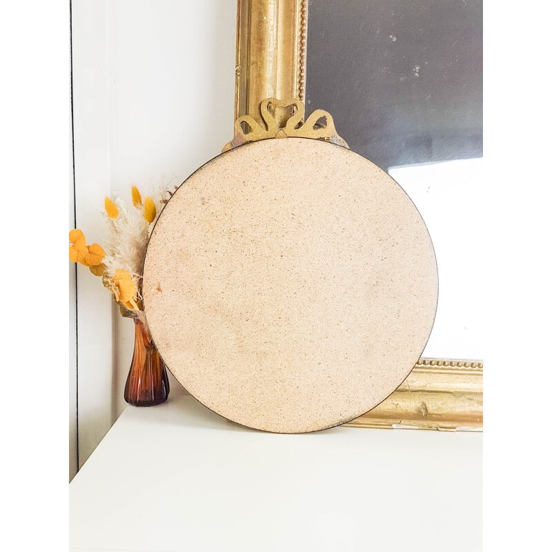 Vintage round brass mirror with 1950's golden bow