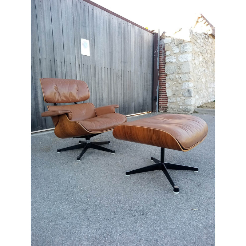 Lounge chair and brown ottoman by Charles Eames for Mobilier International 1990