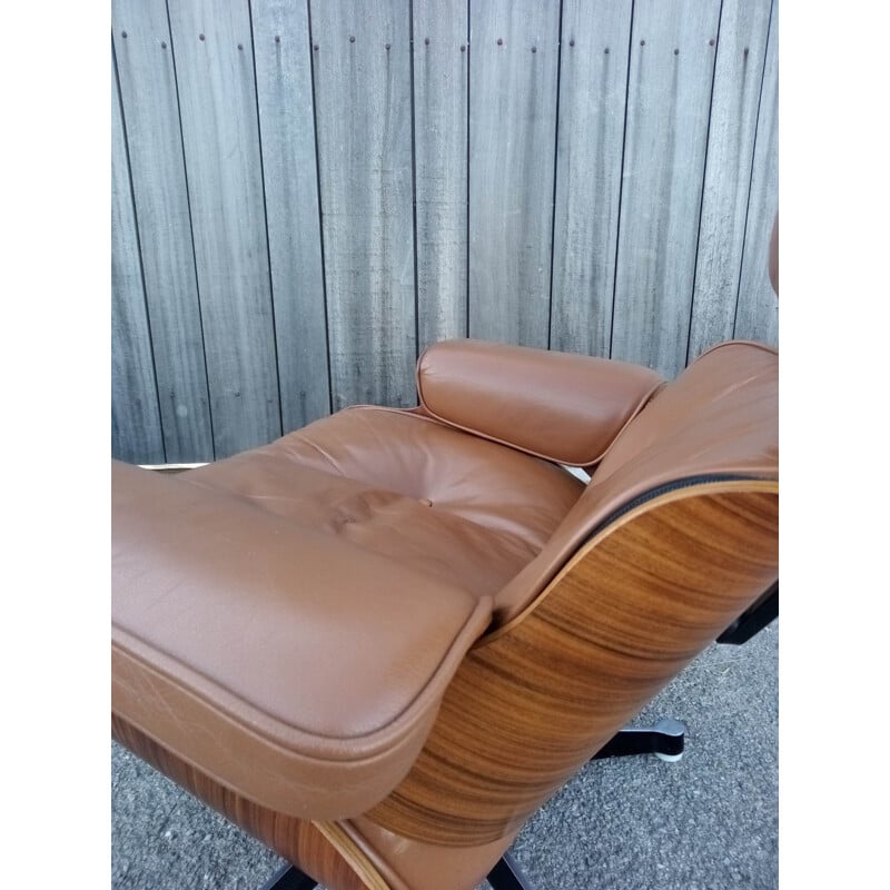 Lounge chair and brown ottoman by Charles Eames for Mobilier International 1990