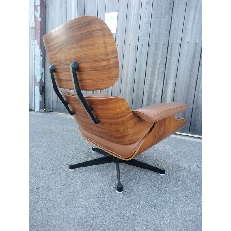 Lounge chair and brown ottoman by Charles Eames for Mobilier International 1990