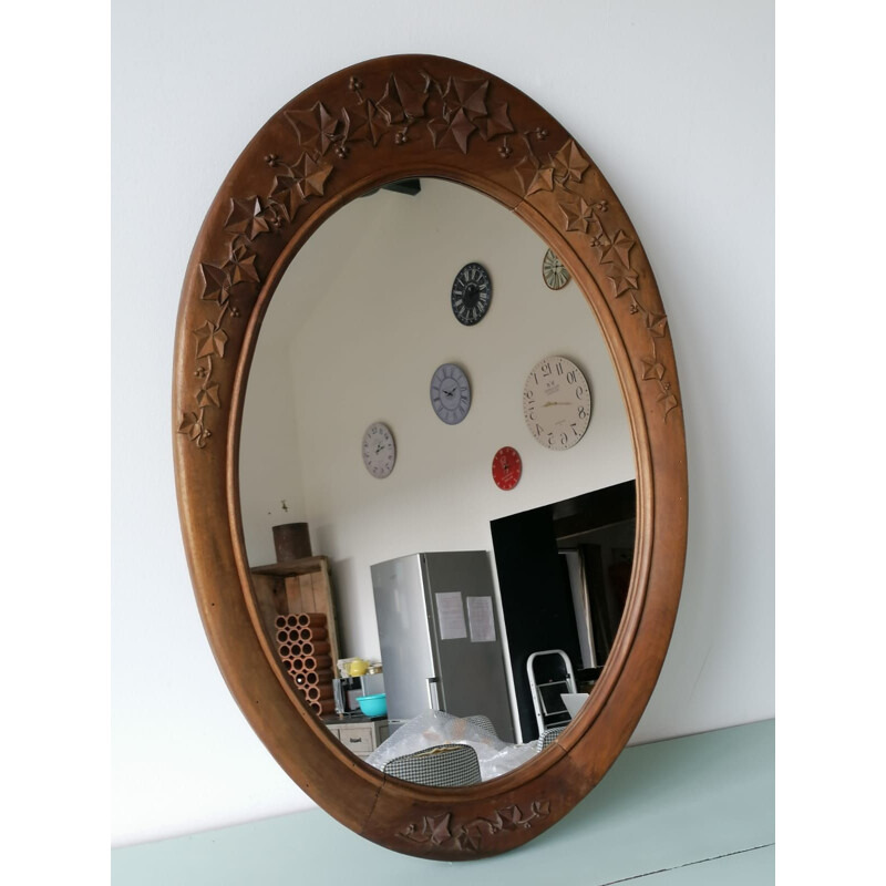 Vintage oval mirror with carved wood frame