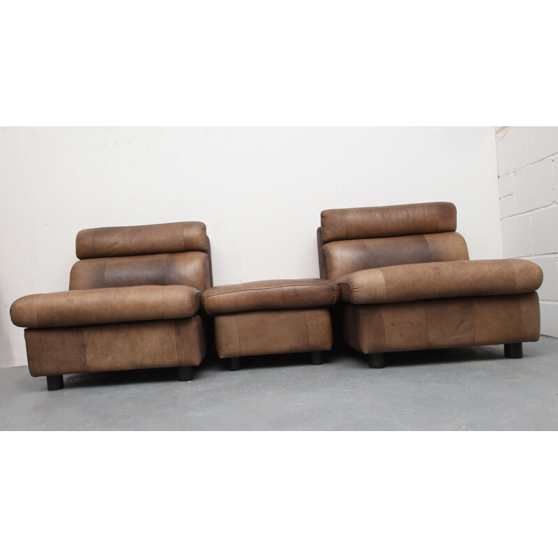 Pair of vintage buffalo leather armchairs and footrests, 1970