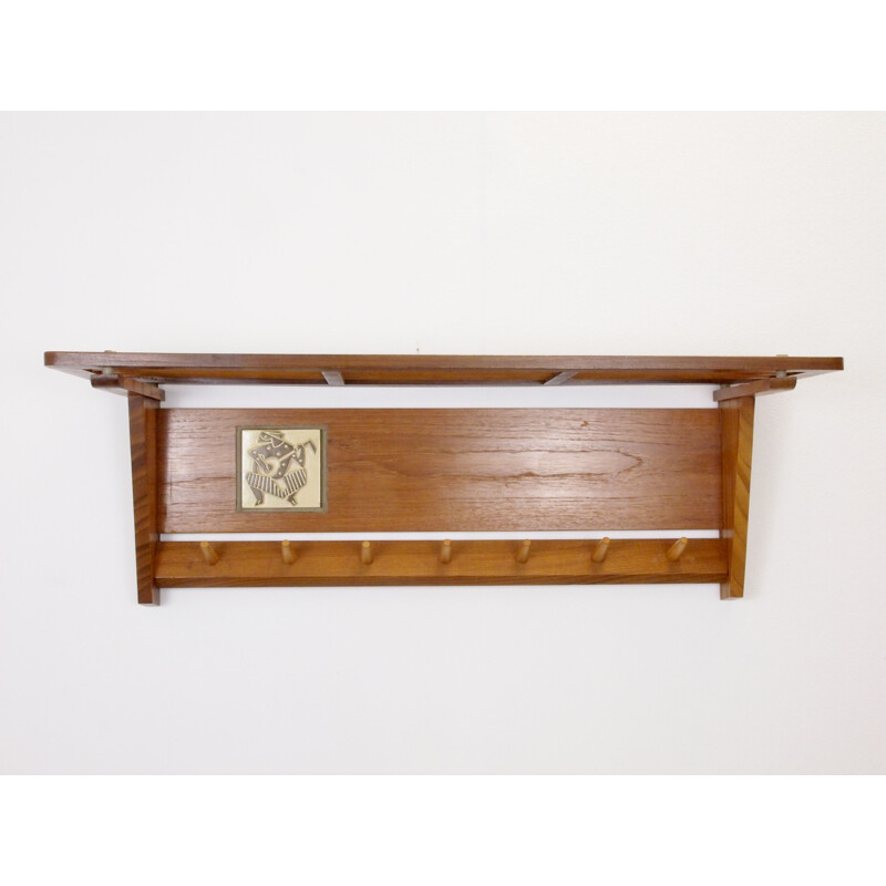 Mid century teak wooden wall mount coat rack decorated with a Jaap Ravelli ceramic tile Dutch