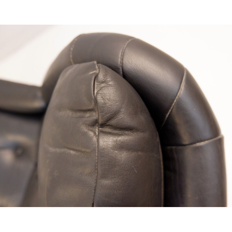 Vintage black leather armchair and pouffe