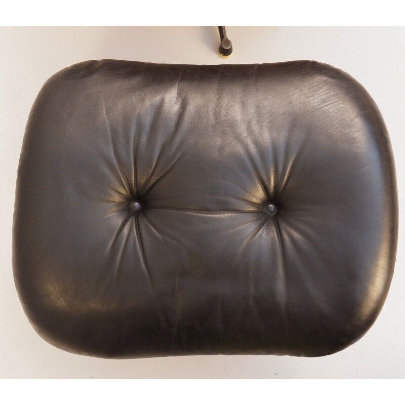 Vintage black leather armchair and pouffe
