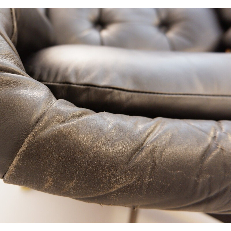 Vintage black leather armchair and pouffe