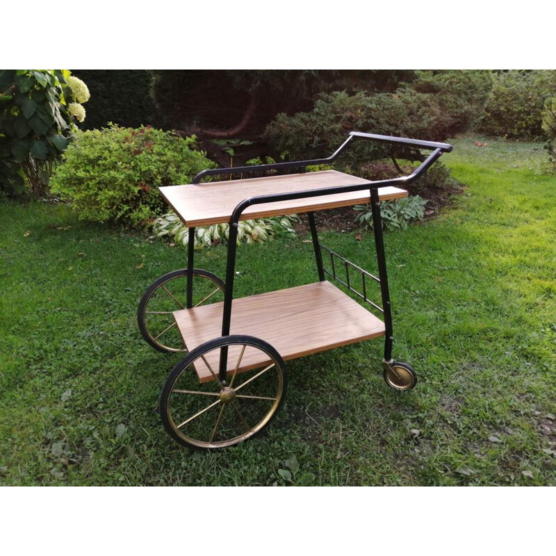 Vintage Bar table on wheels in a with a shelf