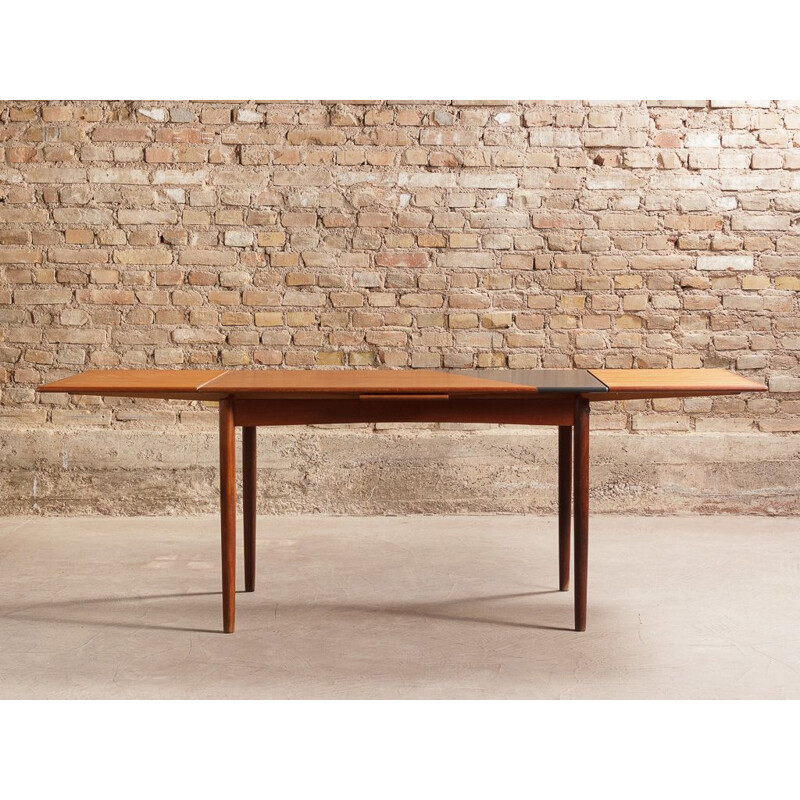 Vintage Danish dining table in solid teak with 2 integrated extensions