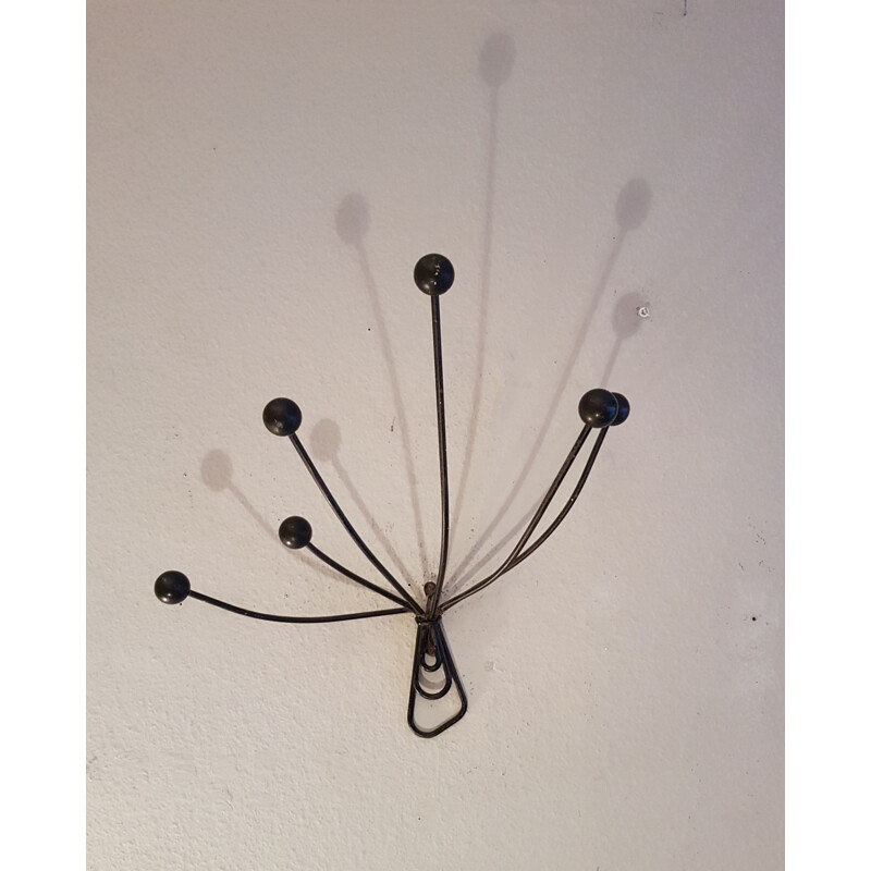 Vintage wall-mounted coat rack in metal and wooden balls
