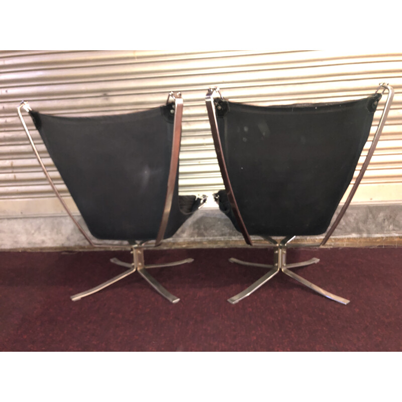 Pair of vintage black Falcon armchairs with ottoman