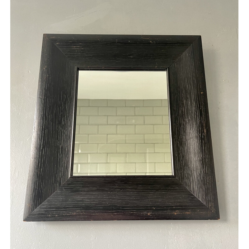Vintage wall mirror with a thick black wooden frame 