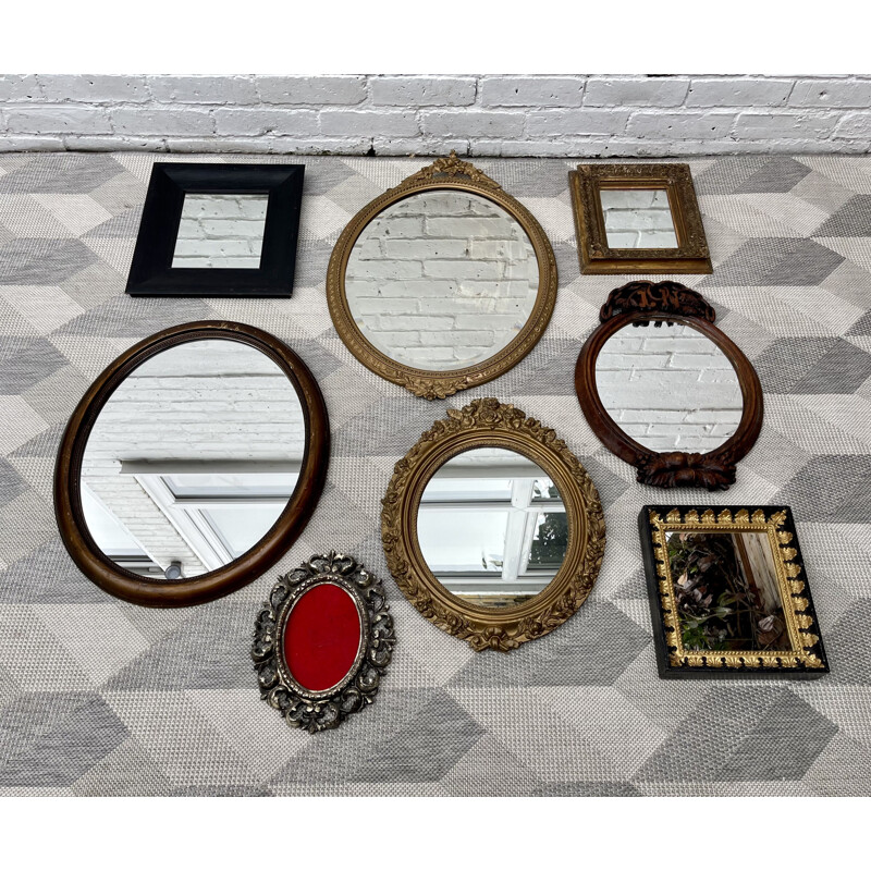 Vintage wall mirror with a thick black wooden frame 