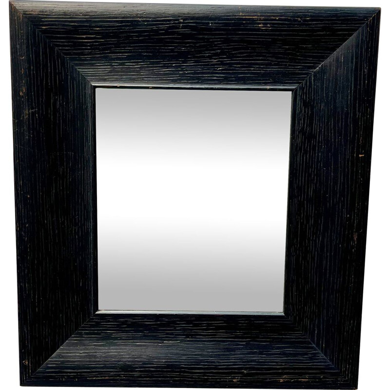 Vintage wall mirror with a thick black wooden frame 