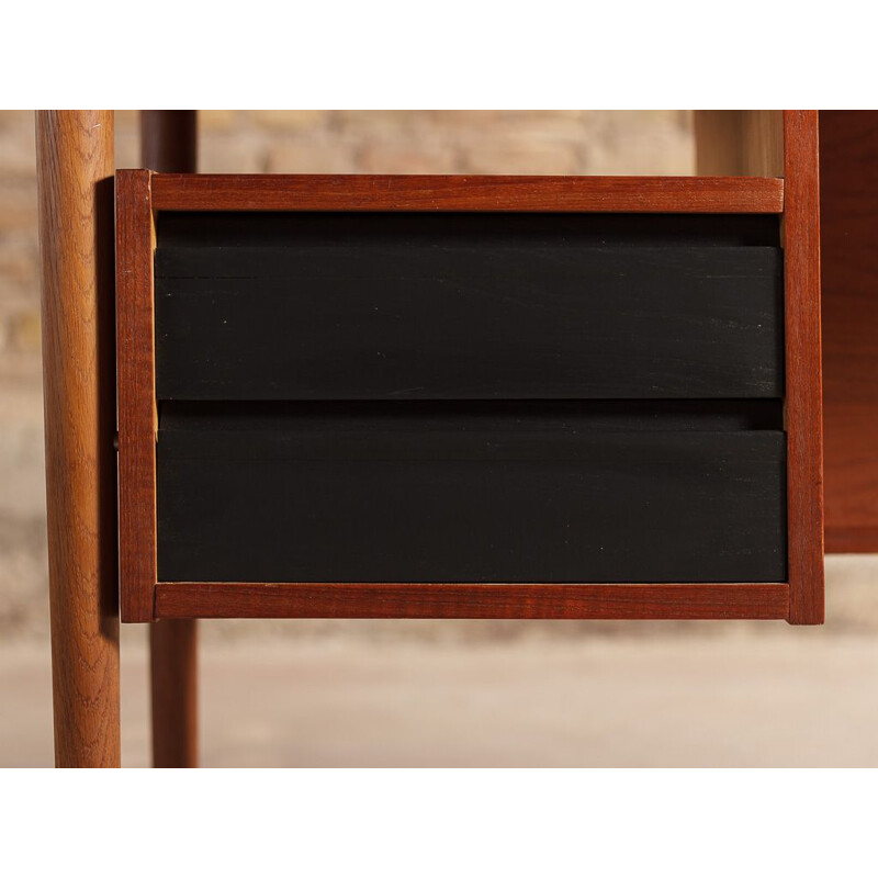 Vintage teak desk with elegant light lines renovated with touches of black 1960s