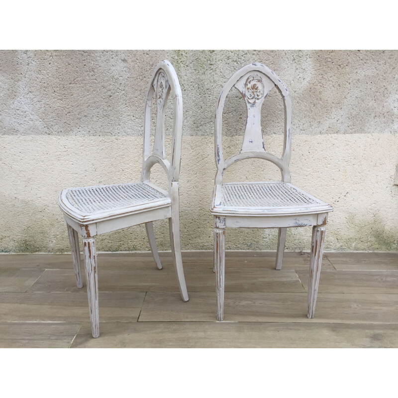 Pair of vintage white caned chairs