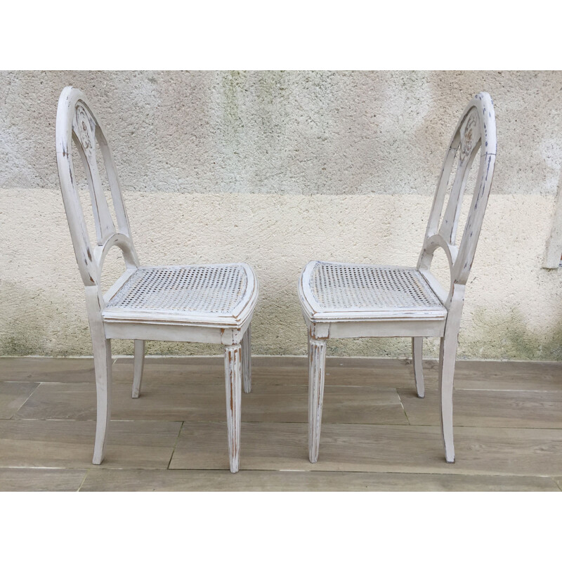 Pair of vintage white caned chairs