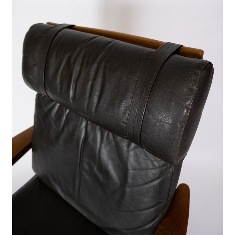 Vintage armchair with teak stool upholstered in black leather by Arne Vodder for Komfort, 1960