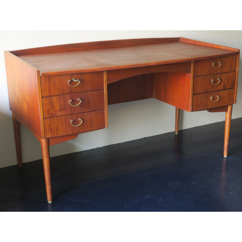 Vintage teak desk with curved shape raised edge and storage space Danish 1960s